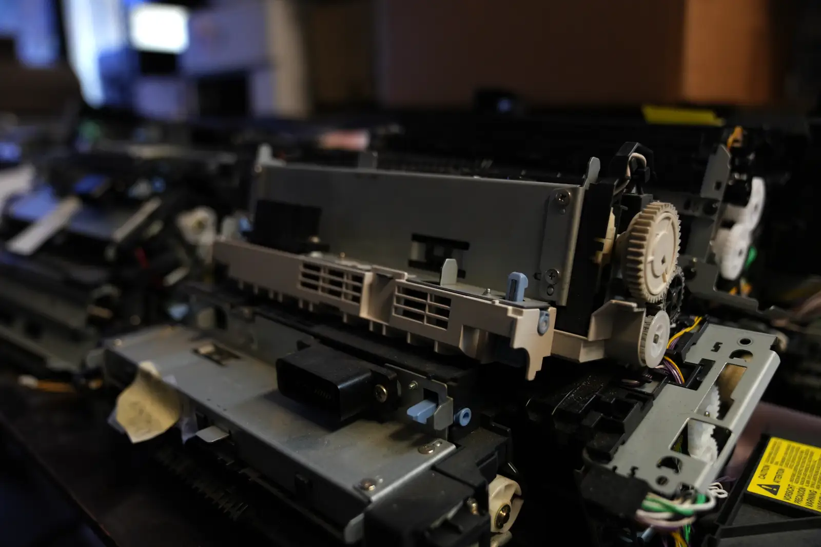 Laser printer fuser assemblies and gears waiting on the repair bench