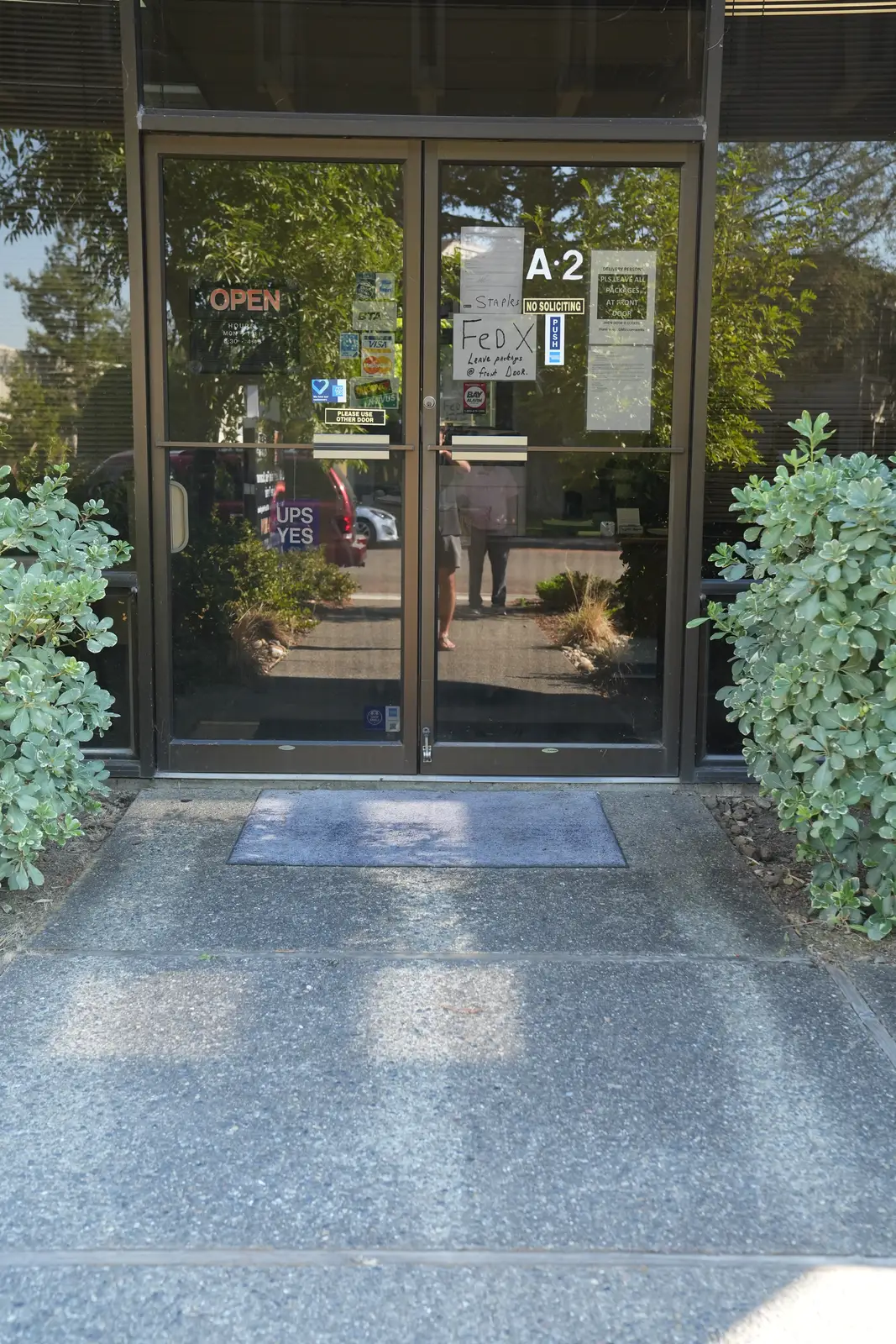 Glass front doors of Suite A-2, the GMS Lazerworks shop entrance