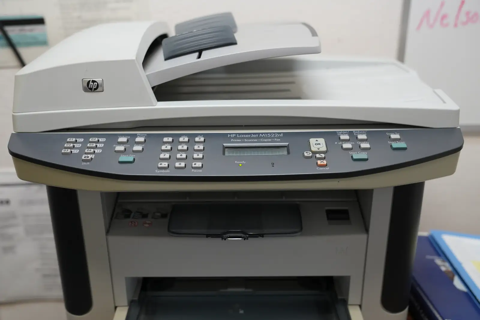 An HP LaserJet multifunction printer with fax keypad and document feeder