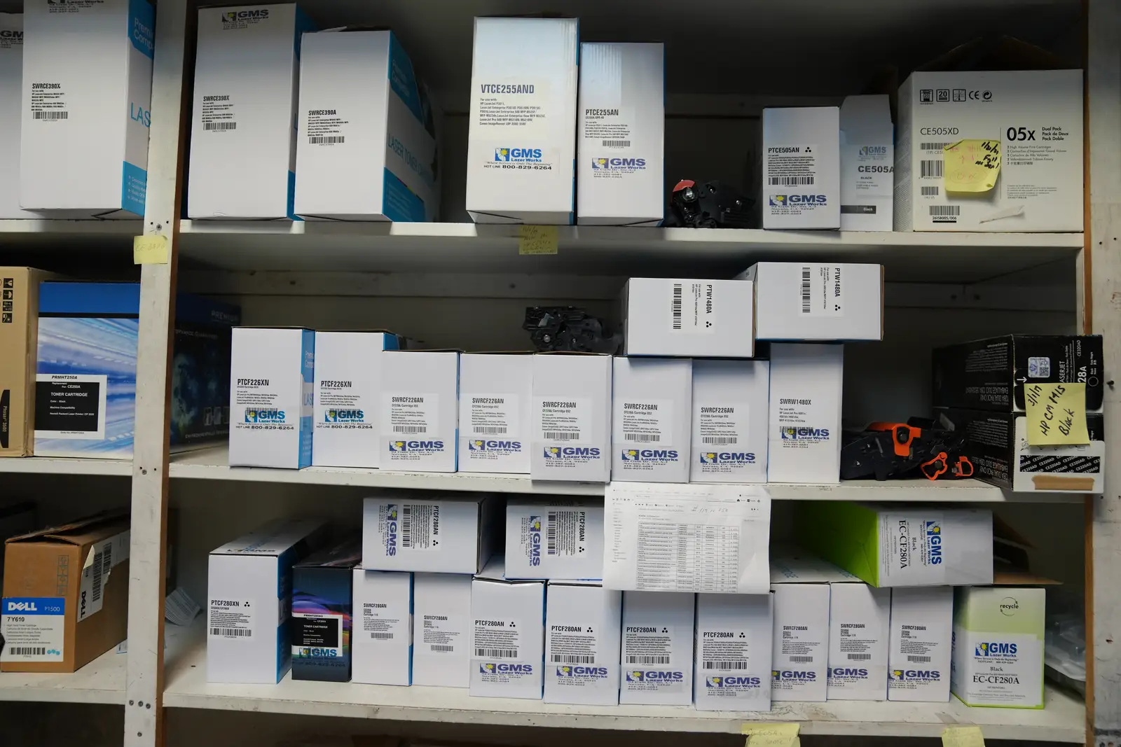 Shelves stocked with boxed toner cartridges at the GMS Lazerworks shop