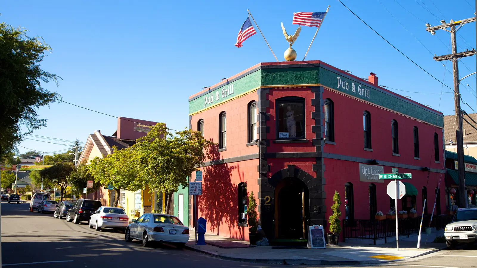 A red historic corner pub building in the Point Richmond Historic District