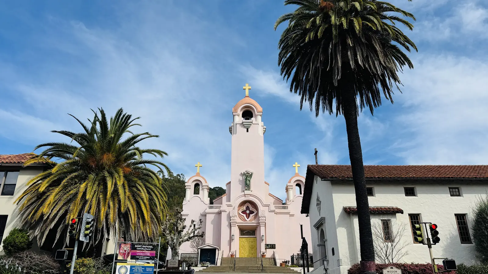 Mission San Rafael Arcángel chapel and bell tower framed by palm trees in downtown San Rafael